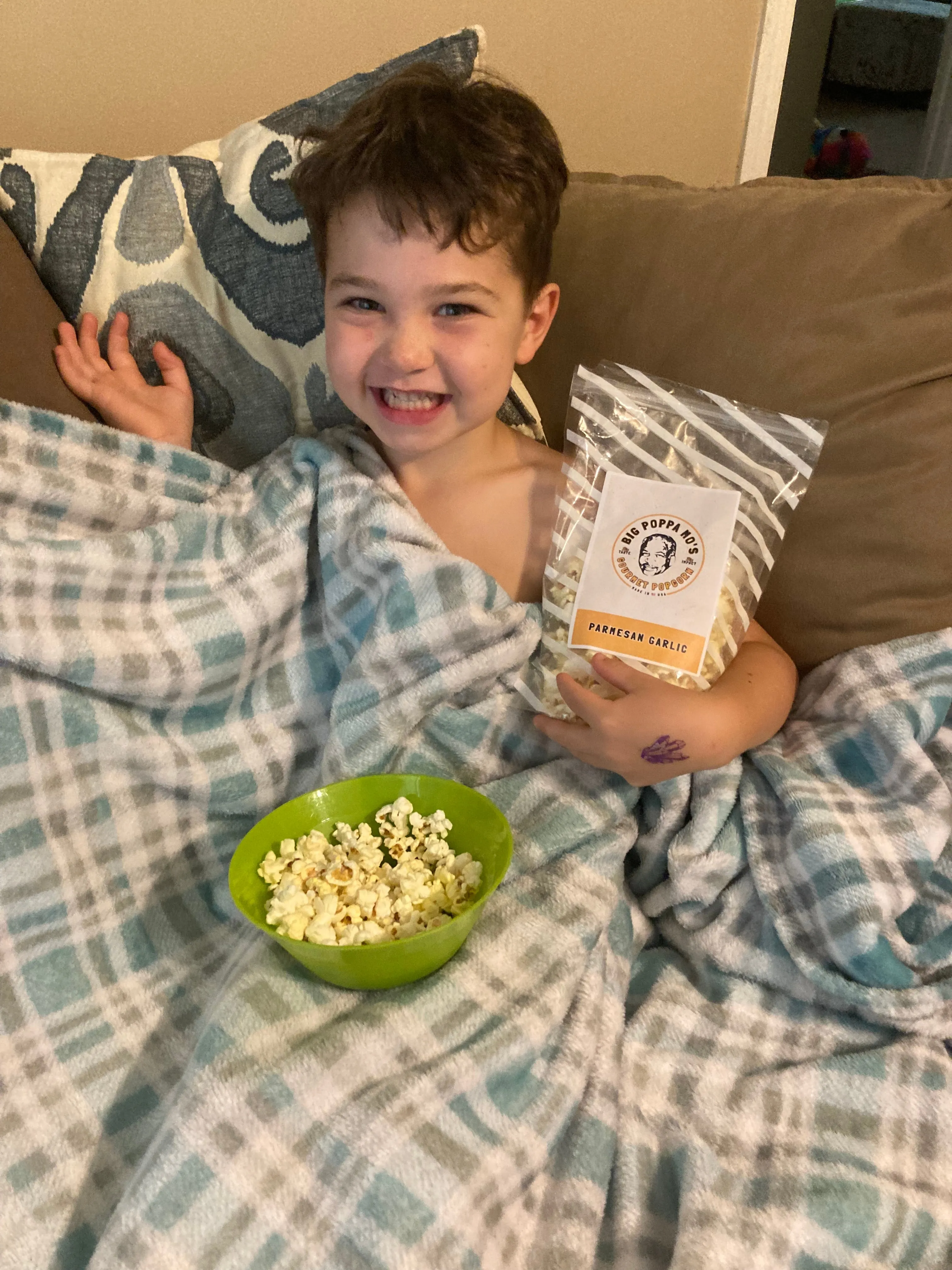 Customer photo with a bag of Parmesan Garlic popcorn and a bowl of popcorn at home.