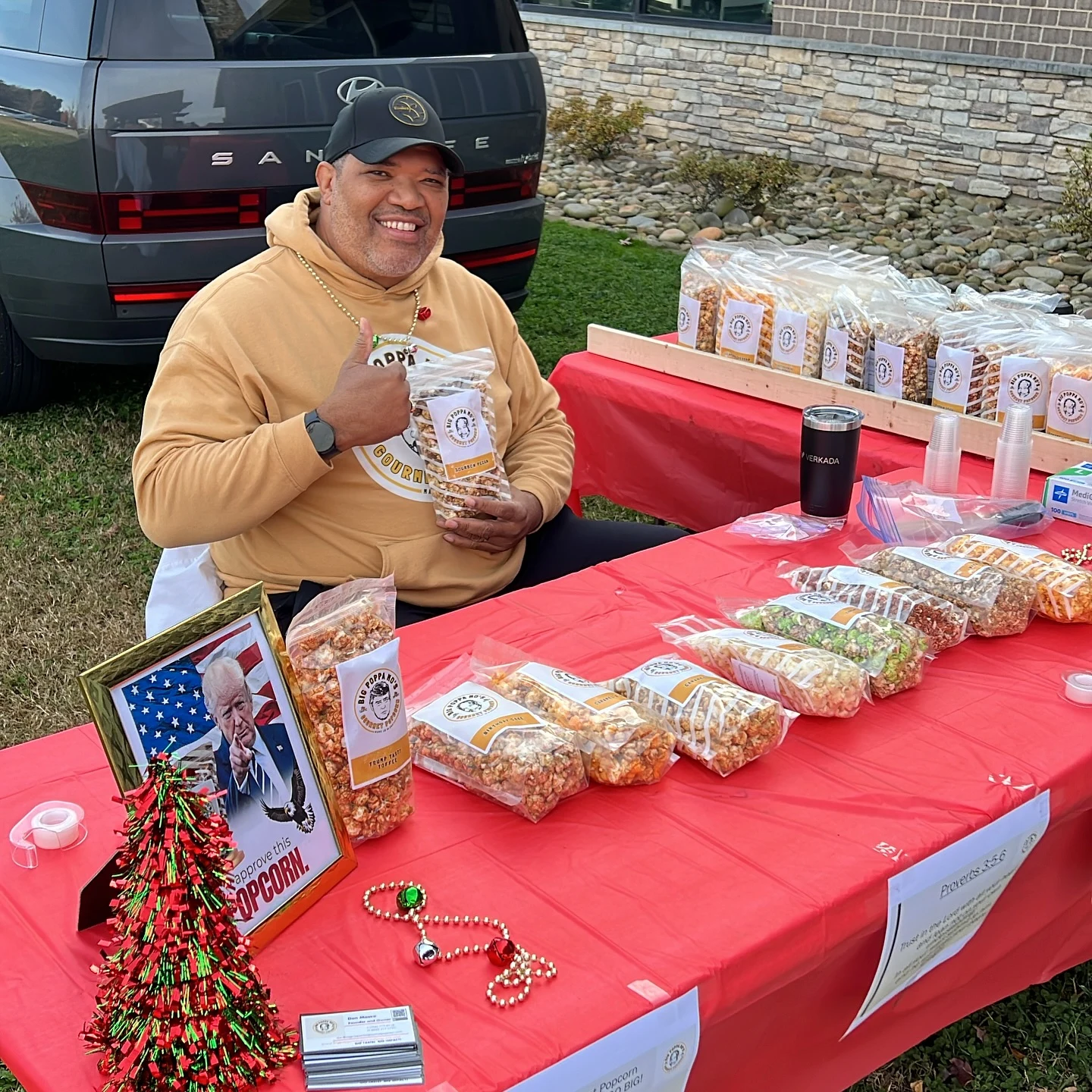 Don Moore smiling and holding a bag of Big Poppa Mo’s popcorn